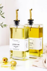 Bottles of vegetable and sunflower cooking oil high in omega-6 fats on a kitchen counter